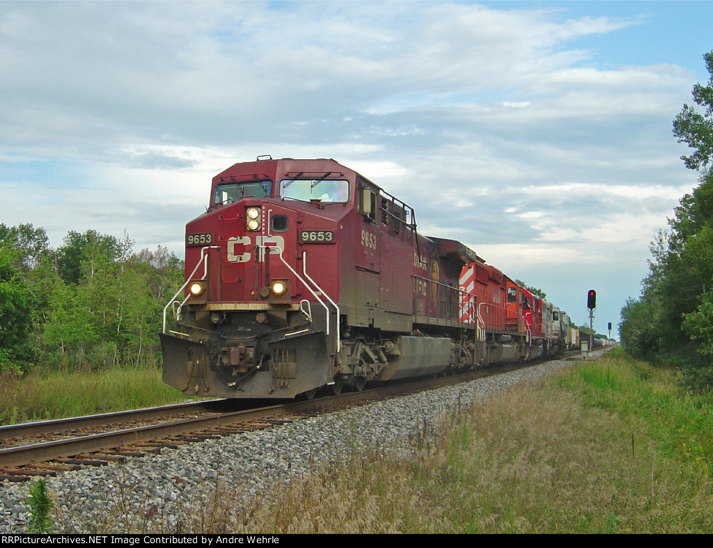 CP 9653 leads a westbound manifest departing the siding